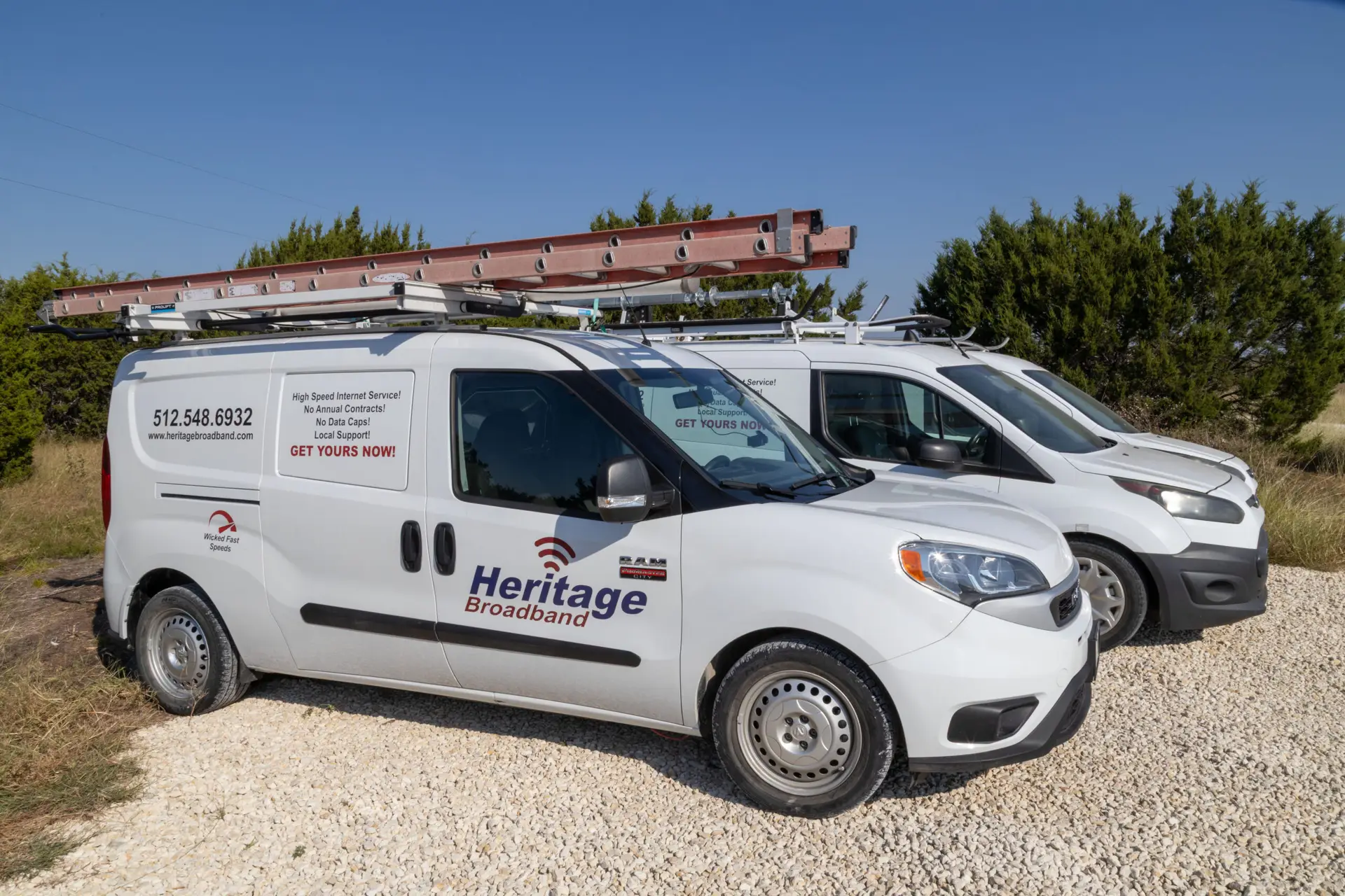 Heritage Broadband field service vehicles delivering fast, local internet across rural Texas. Heritage Broadband service vans equipped with ladders and gear, parked and ready for rural internet installations in Central Texas.