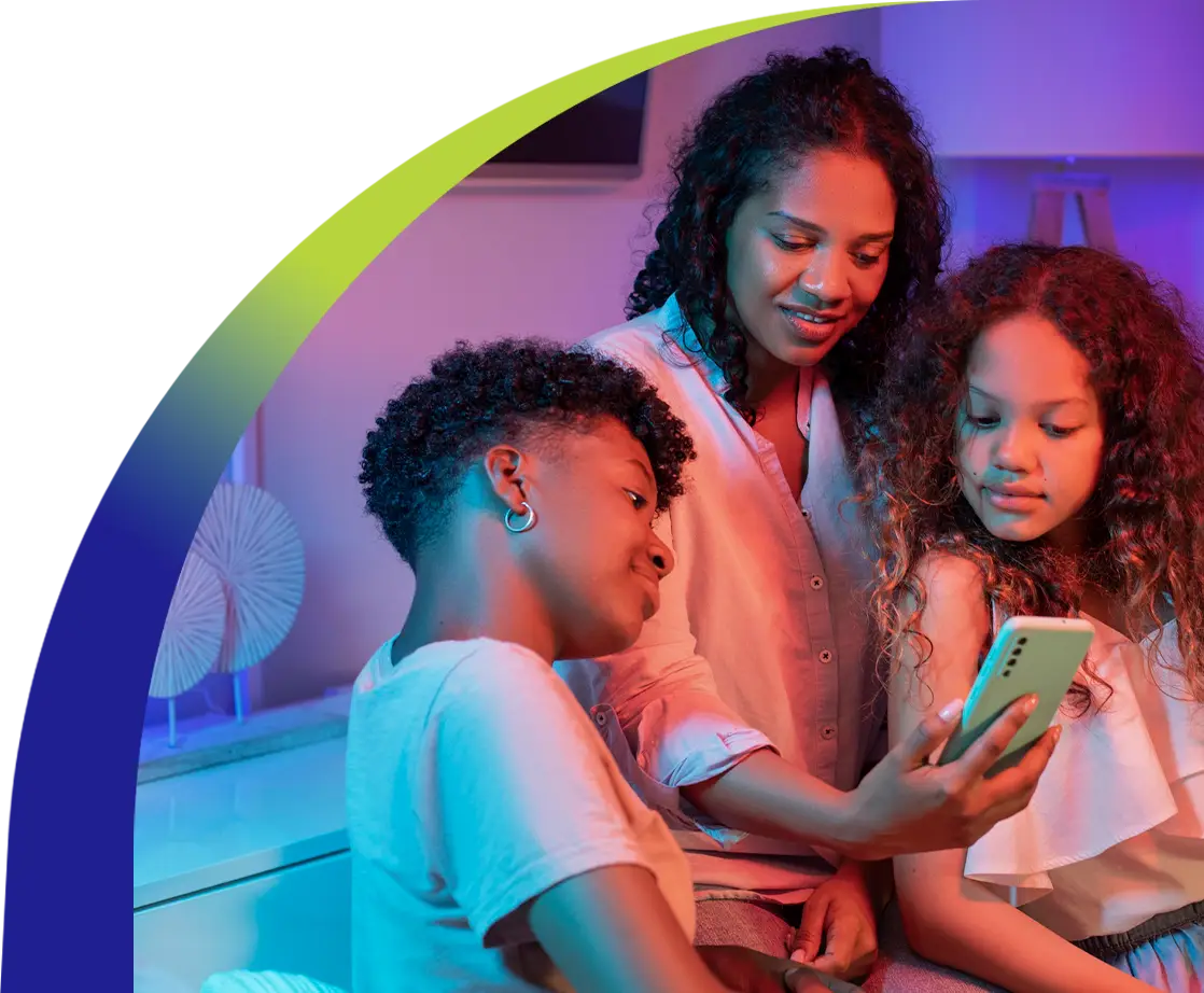 Family enjoying high-speed internet at home, gathered together and streaming content on a smartphone under colorful ambient lighting.